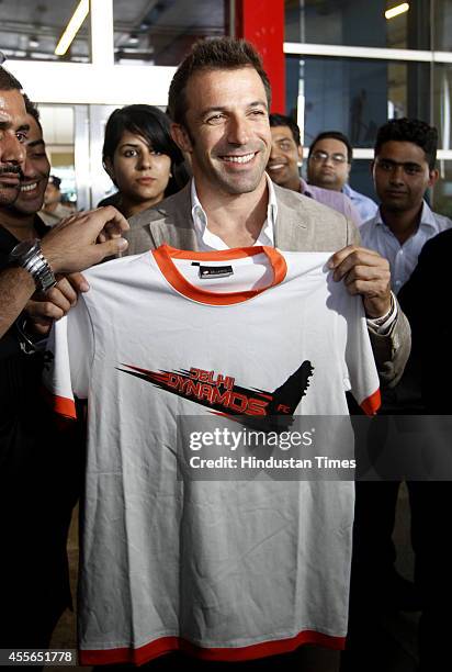 Italian footballer Alessandro Del Piero poses with Delhi Dynamos jersey on his arrival at IGI on September 18, 2014 in New Delhi, India. 2006 Italian...