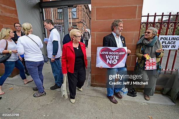 Members of the public walk out of a polling station at Notre Dame primary school following casting their vote in the Scottish independence referendum...