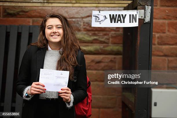 Schoolgirl Ivy Hare, aged 17, a resident of Edinburgh but from Orange County, California, United States, proudly shows of her polling card before...