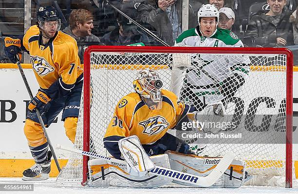 Carter Hutton of the Nashville Predators makes the save with his helmet against the Dallas Stars at Bridgestone Arena on December 12, 2013 in...