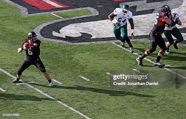 Jordan Lynch of the Northern Illinois Huskies looks for a receiver against the Eastern Michigan Eagles at Brigham Field on October 26, 2013 in...