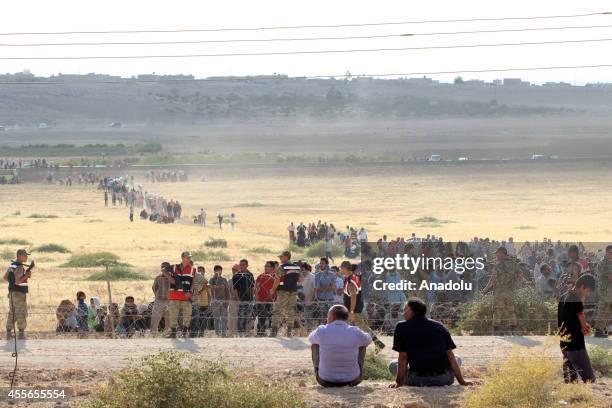 Syrians fleeing from clashes between the Islamic State of Iraq and Levant militants and Democratic Union Party forces in the Ar-Raqqah Governorate of...