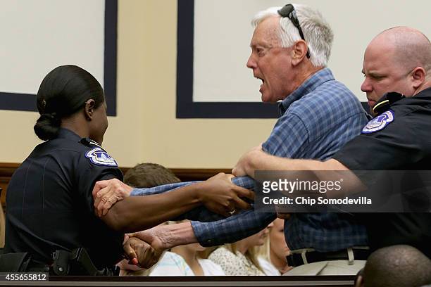 Demonstrator is forcibly removed from a House Armed Services Committee hearing after interrupting Defense Secretary Chuck Hagel as he testified about...