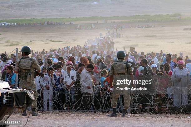 Syrians fleeing from clashes between the Islamic State of Iraq and Levant militants and Democratic Union Party forces in the Ar-Raqqah Governorate of...