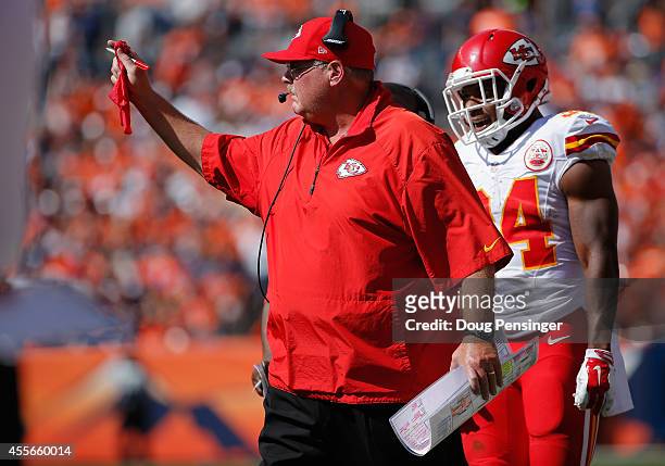 Head coach Andy Reid of the Kansas City Chiefs throws the red to make a coach's challenge against the Denver Broncos at Sports Authority Field at...