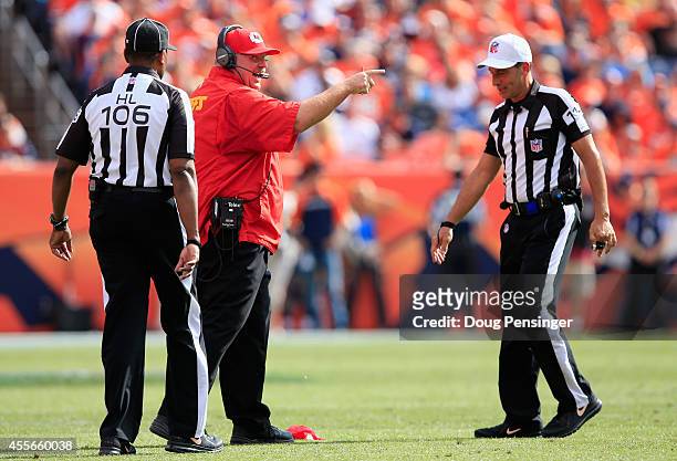 Head coach Andy Reid of the Kansas City Chiefs throws the red to make a coach's challenge with referee Gene Steratore and head linesman Wayne Mackie...
