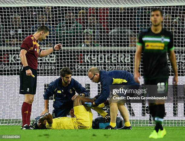 Ikechukwu Uche of Villareal CF is treated after suffering an injury scoring the first goal during the UEFA Europa League Group A match between...