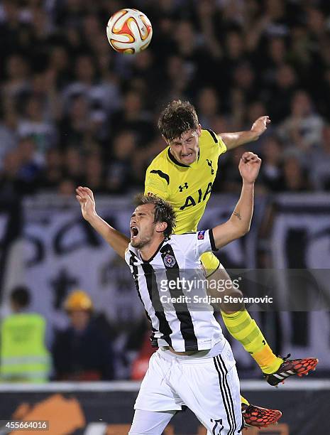 Ben Davies of Tottenham Hotspur jump for the ball over Danko Lazovic of Partizan during the UEFA Europa League match between Partizan and Tottenham...