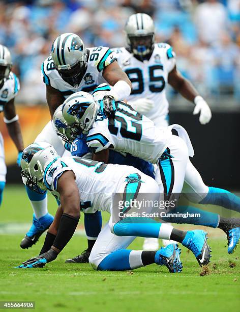 Golden Tate of the Detroit Lions is tackled by Antoine Cason of the Carolina Panthers at Bank of America Stadium on September 14, 2014 in Charlotte,...