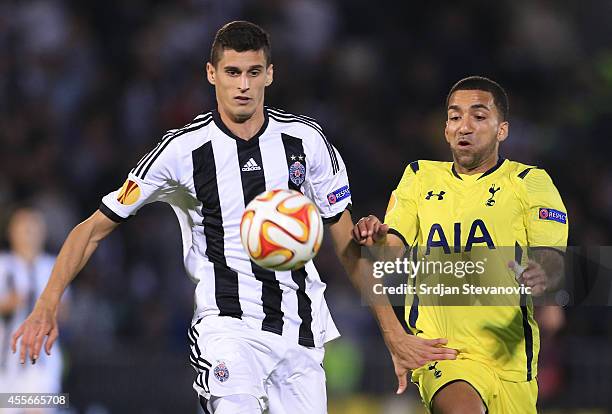 Lazar Cirkovic of Partizan in action against Aaron Lennon of Tottenham Hotspur shake hands after the UEFA Europa League match between Partizan and...