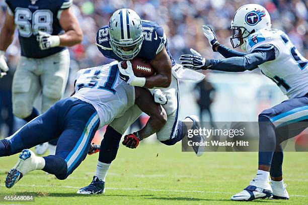 Joseph Randle of the Dallas Cowboys is tackled by Bernard Pollard of the Tennessee Titans at LP Field on September 14, 2014 in Nashville, Tennessee....