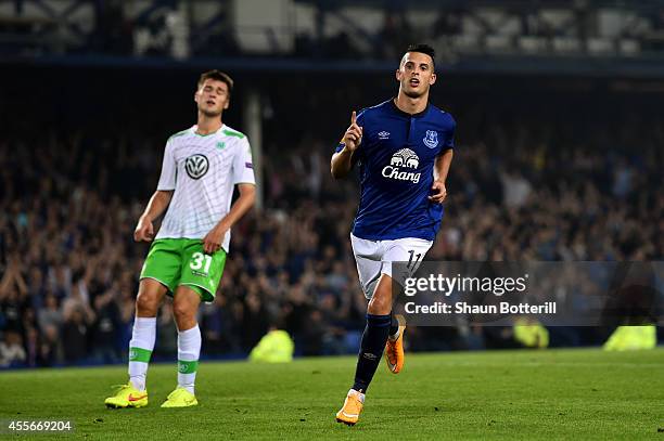 Kevin Mirallas of Everton celebrates after scoring his team's fourth goal whilst a dejected Robin Knoche of VfL Wolfsburg reacts during the UEFA...