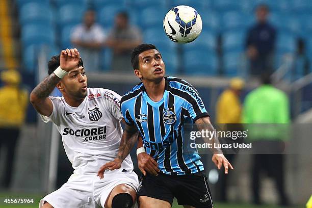 Dudu of Gremio battles for the ball against Gabriel of Santos during the match Gremio v Santos as part of Brasileirao Series A 2014, at Arena do...