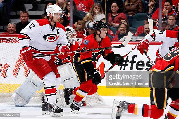 Kris Russell of the Calgary Flames skates against Eric Staal of the Carolina Hurricanes at Scotiabank Saddledome on December 12, 2013 in Calgary,...