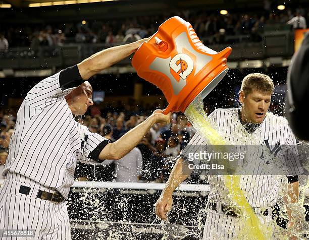 Brett Gardner of the New York Yankees dumps Gatorade on Chase Headley after Headley drove in the game winning run in the bottom of the ninth inning...