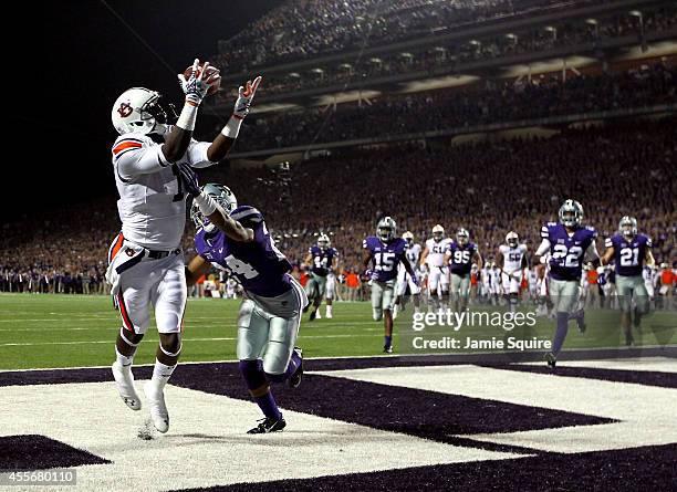 Wide receiver D'haquille Williams of the Auburn Tigers makes a catch in the endzone for a touchdown as defensive back Nate Jackson of the Kansas...