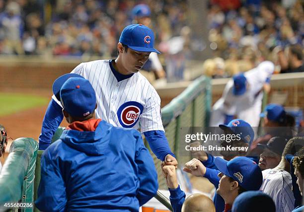 Starting pitcher Tsuyoshi Wada of the Chicago Cubs is congratulated by his teammates after pitching a scoreless fourth inning against the Los Angeles...