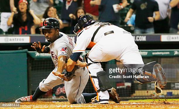 Michael Bourn of the Cleveland Indians is tagged out at home plate by Jason Castro of the Houston Astros in the ninth inning during their game at...