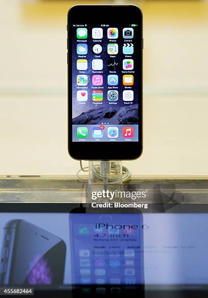 An Apple Inc. IPhone 6 stands on display during the sales launch of the iPhone 6 and iPhone 6 Plus at the company's George Street store in Sydney,...