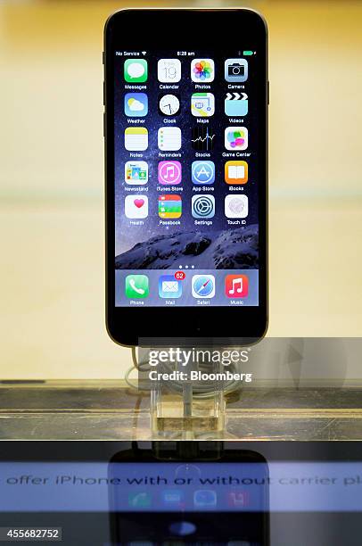 An Apple Inc. IPhone 6 stands on display during the sales launch of the iPhone 6 and iPhone 6 Plus at the company's George Street store in Sydney,...