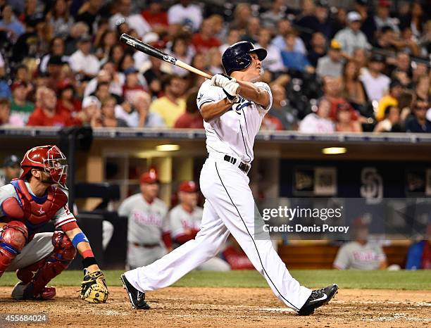 Will Venable of the San Diego Padres hits a three-run home run during the eighth inning of a baseball game against the Philadelphia Phillies at Petco...