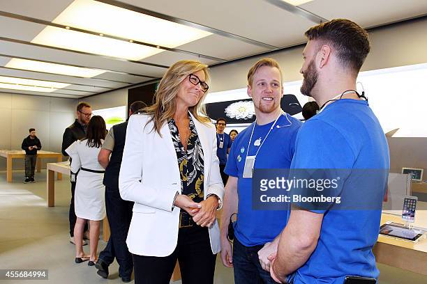 Angela Ahrendts, senior vice president of retail and online stores at Apple Inc., left, chats with employees at the company's George Street store...