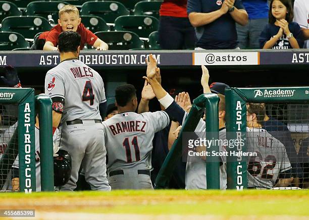 Jose Ramirez of the Cleveland Indians celebrates with his teammates after scoring a run in the 13th inning against the Houston Astros during their...