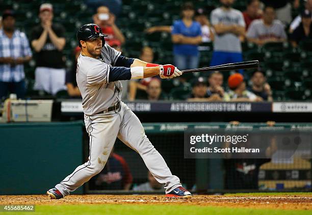 Mike Aviles of the Cleveland Indians drives in a run in the 13th inning against the Houston Astros during their game at Minute Maid Park on September...