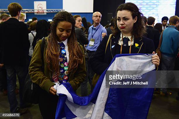Two dejected Yes vote campaigners look on after the result of the Scottish referendum on independence is announced at the count centre for the...