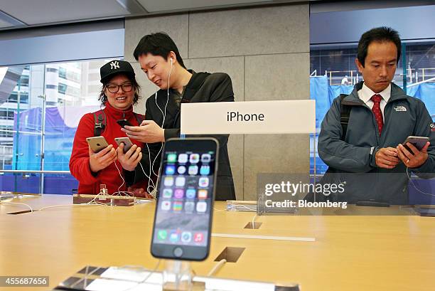 Customers try out the iPhone 6 and iPhone 6 Plus at the Apple Inc. George Street store during the sales launch of the iPhone 6 and iPhone 6 Plus in...
