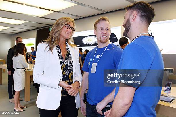 Angela Ahrendts, senior vice president of retail and online stores at Apple Inc., left, chats with employees at the company's George Street store...