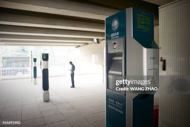 Charging piles are set up at a charging station under a overpass in Beijing on September 19, 2014. Chinese cities are plagued by heavy air pollution,...