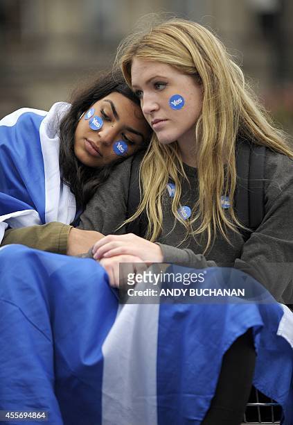 Pro-independence supporters console each other in George Square in Glasgow, Scotland, on September 19 following a defeat in the referendum on...