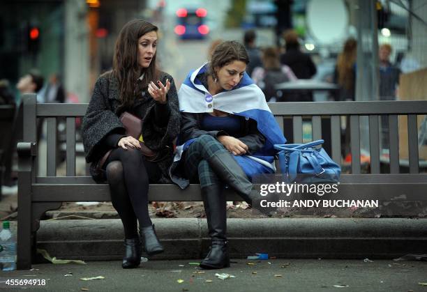 Pro-independence supporters console each other in George Square in Glasgow, Scotland, on September 19 following a defeat in the referendum on...