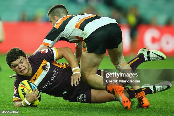 Ashley Taylor of the Broncos is tackled during the 1st Holden Cup Semi Final match between the Brisbane Broncos and the Wests Tigers at Allianz...