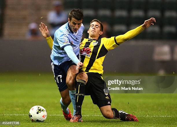 Terry Antonis of Sydney is tackled by Alex Rodriguez of the Phoenix during the A-League pre-season match between Sydney FC and the Wellington Phoenix...
