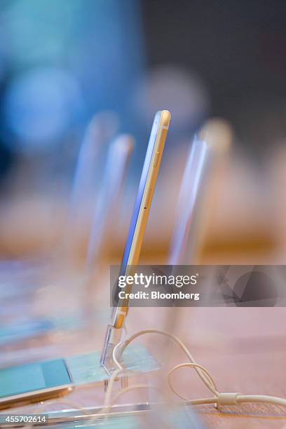 Apple Inc.'s iPhone 6 smartphones stand on display during the sales launch of the iPhone 6 and iPhone 6 Plus at the Apple store in Berlin, Germany,...