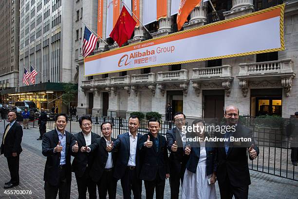 Executive Chairman of Alibaba Group Jack Ma and other executives pose for a photo outside the New York Stock Exchange prior to the compadsny's...
