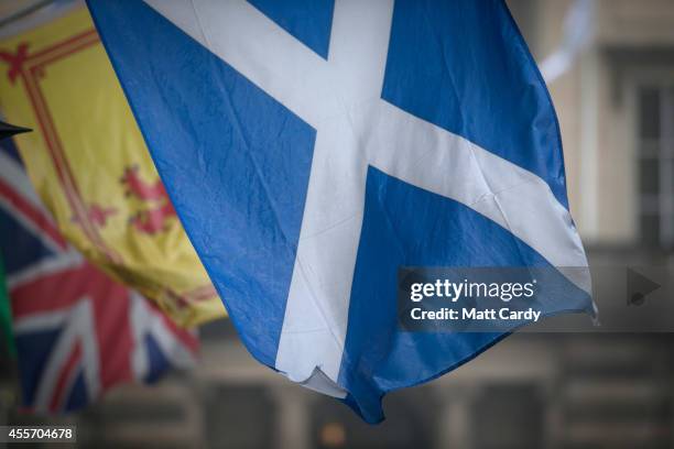 The Saltire, the Royal Standard of Scotland and the Union Flag fly above a gift shop in central Edinburgh on September 19, 2014 in Edinburgh,...