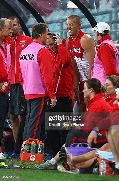 Sam Reid of the Swans leaves the ground with a leg injury during the 1st Preliminary Final AFL match between the Sydney Swans and the North Melbourne...