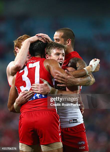 Luke Parker of the Swans congratulates Adam Goodes of the Swans after he kicked a goal during the 1st Preliminary Final AFL match between the Sydney...
