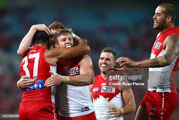 Luke Parker of the Swans congratulates Adam Goodes of the Swans after he kicked a goal during the 1st Preliminary Final AFL match between the Sydney...