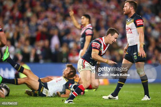 James Maloney of the Roosters celebrates kicking the winning field goal during the 1st NRL Semi Final match between the Sydney Roosters and the North...