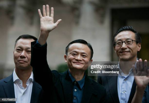 Billionaire Jack Ma, chairman of Alibaba Group Holding Ltd., center, waves while standing for a photograph with Jonathan Lu, chief executive officer...