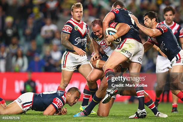 Matt Scott of the Cowboys is tackled on his way to score a try during the 1st NRL Semi Final match between the Sydney Roosters and the North...