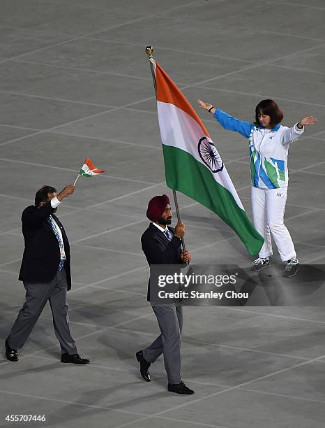 Shardar Singh of India carries the country's flag during the Opening Ceremony ahead of the 2014 Asian Games at Incheon Asiad Main Stadium on...