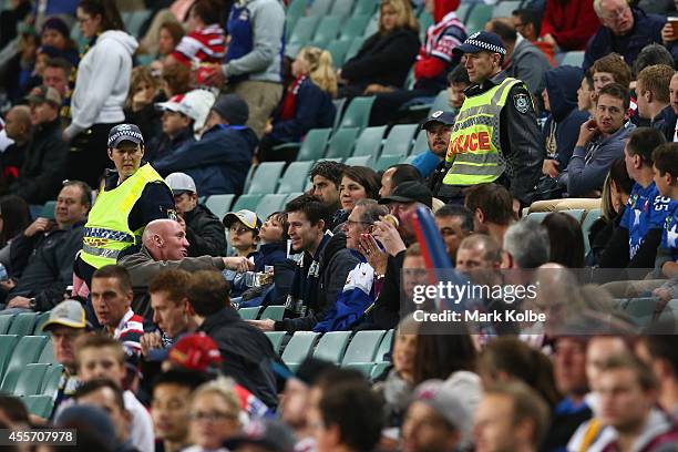 Police officers monitor spectators during the 1st NRL Semi Final match between the Sydney Roosters and the North Queensland Cowboys at Allianz...