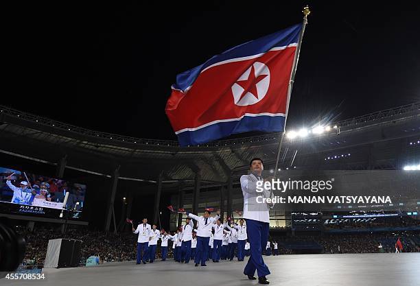 North Korea's Sok Yongbom leads their delegation parade during the opening ceremony of the 2014 Asian Games at the Incheon Asiad Main Stadium in...