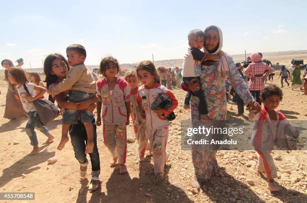 Syrians fleeing from clashes between the Islamic State of Iraq and Levant militants and Democratic Union Party forces in the Ar-Raqqah Governorate of...