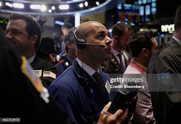 Trader works on the floor of the New York Stock Exchange in New York, U.S., on Friday, Sept. 19, 2014. Alibaba Group Holding Ltd., the e-commerce...